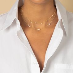 Adina Eden’s Dainty Pearl X CZ Necklace, crafted from brass and plated in 14K gold, is a delicate blend of timeless elegance and modern sparkle. Featuring a faux pearl centerpiece accented by clear cubic zirconia stones, this necklace adds a subtle yet refined touch to any outfit. With an adjustable length of 14 inches plus a 3-inch extender, it offers versatile styling options, perfect for layering or wearing solo. This piece is a must-have for those who appreciate understated luxury. Product D Dangling Necklace, Pearl Centerpiece, Layered Pearl Necklace, Understated Luxury, Cz Necklace, Cz Stone, Bezel Setting, Pearl White, Faux Pearl