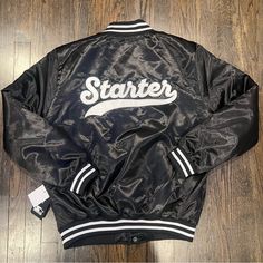 Starter Script Satin Bomber Jacket Size Large. Nwt Fitted Varsity Outerwear For Work, Black Fitted Long Sleeve Varsity Jacket, Black Varsity Outerwear For Spring, Varsity Fitted Outerwear For College, Varsity Style Fitted Outerwear For College, Urban Fitted Outerwear With Letter Print, Fitted Urban Outerwear With Letter Print, Fitted Black Varsity Jacket For Streetwear, Fitted Black Outerwear For College