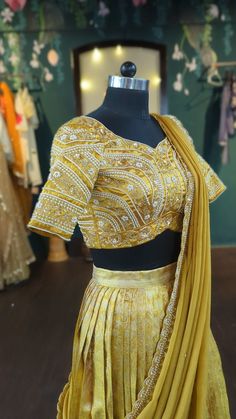 Silk pattu pavada set in beautiful deep gold. Pearl embroidery blouse and matching gold dupatta. Size: Please choose a standard size from the drop-down or your can choose custom measurements. if you choose custom measurements, I'll send you a measurements chart which you can fill out. please contact me for any customisation or if you need this in other colours. Designer Embroidered Gold Pre-draped Saree, Designer Gold Embroidered Pre-draped Saree, Semi-stitched Gold Pre-draped Saree With Dupatta, Gold Embroidered Silk Pre-draped Saree, Gold Embroidered Art Silk Pre-draped Saree, Gold Silk Pre-draped Saree With Intricate Embroidery, Gold Pre-draped Saree With Intricate Embroidery For Reception, Gold Pre-draped Dola Silk Saree With Dupatta, Yellow Chinon Traditional Wear With Intricate Embroidery