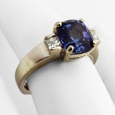 "Vintage 14 K (.585) white gold statement ring, decorated with Tanzanite stone and two Diamonds. This great ring is a size 6 3/4, 6/8\" wide and weighs 5.8 grams. The center stone is 8.3 x 7.9 x 5.8 or estimated 2.3 ct. (the facets are slightly abraded and there is a scratch on the table). Diamonds are approx. 0.28 ctw, VS clarity, color G-H. EA1736" Antique Jewelry Rings, Statement Rings Diamond, Tanzanite Stone, Tanzanite Diamond, Gold Statement Ring, Gold Sign, Statement Ring, Rings Statement, Vintage Watches