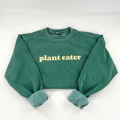 "This comfy, heavyweight vegan activism crewneck sweatshirt features our \"Plant Eater\" graphic on the front and is blank on the back. Material: 80% ringspun cotton, 20% polyester that is preshrunk, soft-washed, and made from garment-dyed fabric. Fit: Unisex. Make sure to check the size chart (swipe through photos). Care: Wash inside out and tumble dry low or hang dry. Do not iron or dry clean." Crew Neck Slogan T-shirt For Fall, Sporty Long Sleeve Organic Cotton Sweatshirt, Green Screen Print Sweatshirt For Streetwear, Organic Cotton Sporty Sweatshirt For Streetwear, Sporty Organic Cotton Sweatshirt For Streetwear, Organic Cotton Sweatshirt For Everyday Fall Wear, Casual Organic Cotton Sweatshirt For Everyday, Long Sleeve Organic Cotton Tops For Streetwear, Fall Cotton Sweatshirt With Screen Print