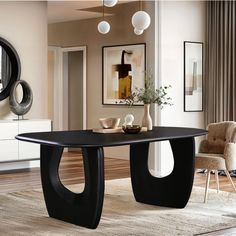 a black table in a living room next to a chair and mirror on the wall