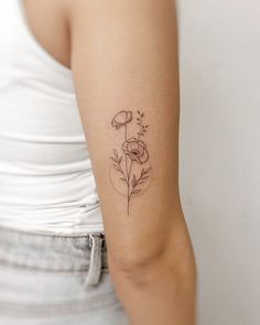 a woman with a flower tattoo on her arm