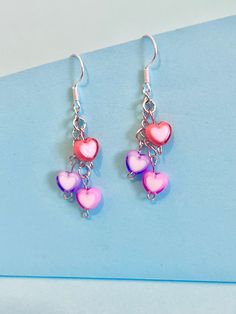 Heart cluster dangler earrings, to brighten up your day. Dainty and cute. Perfect Valentine present. The hook is plated sterling silver to protect your ears and the the love hearts are made of polymer. They come well presented and wonderful for a birthday present for a friend, family or your loved one. I offer free postage and will despatch within a day of purchase Thank you for taking the time to look at my earrings and please visit my UK shop for more original designs.  Bespokedanglers. Thanks Trendy Dangle Heart Earrings For Valentine's Day, Trendy Dangle Heart Earrings, Trendy Pierced Heart Dangle Earrings, Hypoallergenic Pink Heart Earrings In Sterling Silver, Hypoallergenic Pink Sterling Silver Heart Earrings, Playful Pink Earrings For Valentine's Day, Trendy Dangle Heart Earrings With Ear Wire, Pink Sterling Silver Heart Earrings For Mother's Day, Playful Purple Dangle Jewelry