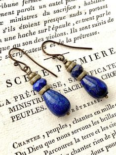 Gorgeous Lapis Lazuli and brass drop earrings in vintage style on hand forged brass ear wires. The earrings may be changed to lever back ear wires or post style earrings. See last picture for reference. You will be prompted to select your preference when you add them to your cart.  They measure appx 1 3/4 inches from top of wire. 👑 More Lapis Lazuli Earrings https://www.etsy.com/shop/tinygoldcrowns?ref=simple-shop-header-name&listing_id=903472731&search_query=Lapis+lazuli+earrings 👑 More Dangl Handmade Bronze Brass Teardrop Earrings, Blue Gemstone Earrings, Lapis Earrings, Lake Elsinore, Lapis Lazuli Earrings, Crystal Dangle Earrings, Purple Art, Art Deco Necklace, Pearl Earrings Dangle