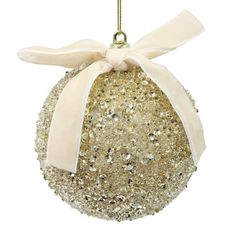 a christmas ornament with a bow on it's back and gold sequins