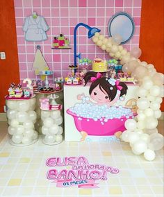 a pink bathroom with balloons and decorations on the walls, along with a bathtub filled with bubbles