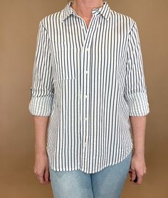 The Marina top is effortlessly beautiful with textured stripes, a split hem & a single chest pocket. Made from 100% cotton, this stylish striped shirt is versatile enough to pair with any casual denim and sandals or work wear. Let it be your go-to piece for classic, effortless fashion. Details: 100% Cotton Button up blouse Single front pocket Split hem Roll tab sleeves Fit: true to size, Amber is modeling size Small. Contents: 100% Cotton Imported Trendy Striped Workwear Shirt, Casual Striped Blouse For Work, Spring Horizontal Stripe Button-up Shirt, Spring Button-up Shirt With Horizontal Stripes, Casual Shirt With Contrast Stripes For Work, Casual Workwear Shirt With Contrast Stripes, Casual Vertical Stripe Top For Work, Spring Shirt With Contrast Stripes, Casual Vertical Stripes Workwear Blouse