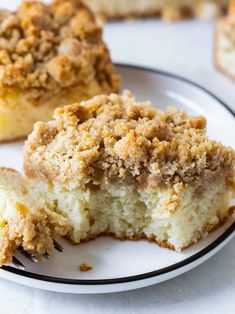 a piece of coffee cake on a white plate with a fork in front of it