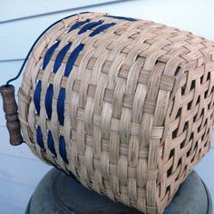 a woven basket sitting on top of a metal object