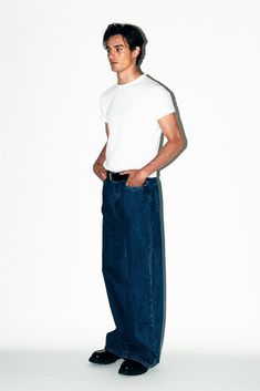 A pair of relaxed straight-leg jeans inspired by the boyish minimalism of the 90's. Designed to be perfectly roomy around the leg without looking overly baggy. Canon is a go-with-everything pair of forever denim. Canon fits loose but not baggy. A more relaxed fit than our Rodeo Classic Straight Leg Jeans but less baggy than our Laurel Wide-Leg Jeans. Early 2000s Fashion Photoshoot, 90s Calvin Klein Ads Men, Wide Fit Jeans Outfit Men, Male Fashion Colorful, Dark Wash Blue Jeans Outfit, Baggy Jeans Mens Outfit, Men’s Fashion Jeans, 90s Minimalism Fashion Men, Wide Jeans Outfit Men