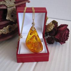 Vintage 8 kt gold amber necklace Amber pendant marked 333 on bail Amber size43,223,7 mm and52,3 mm drop down with bail Necklace is marked 333 on closure It is 18 inch long and 1,1 mm wide Total weight is 7,65 gram the display box is not included. Pendant will arrive in a gift box PLEASE NOTE: we sell items as is, and we set price accordingly. Pictures and videos are part of description. Feel free to request more pictures and description if needed read our return and exchange policy. Birthstone: Baltic Amber Gemstone Necklaces, Elegant Yellow Baltic Amber Necklaces, Formal Oval Amber Necklace, Amber Pendant Necklace In Baltic Amber, Classic Amber Pendant Necklace, Classic Amber Necklace As Gift, Classic Amber Necklace Gift, Amber Hallmarked Necklaces For Gifts, Classic Amber Necklace For Gift