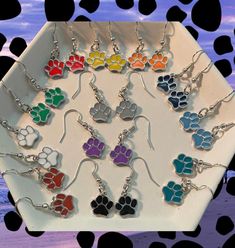 Multicolor paw print charms crafted into beautiful dangle/drop earrings for any occasion. There are several color options to choose from in this set of earrings. Options are pictured as examples in the photos posted. Please select the number of your favorite earring when purchasing. All earrings come with rubber backings and are 100% handmade. Paw Print Charm, Paw Print, Jewelry Earrings Dangle, Color Options, Etsy Earrings, Dangle Drop Earrings, Dangle Earrings, Jewelry Earrings, Charms