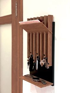 a wooden shelf with keys and knives on it