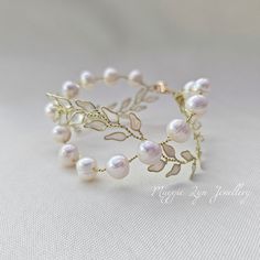 This Handmade Freshwater Pearl Bracelet is an exquisite piece of jewelry perfect for any special occasion. Its chunky pearls and handpainted enamel leaf design add a touch of elegance and uniqueness to any bridal or wedding jewelry collection. The bracelet is intricately crafted with genuine crystals, freshwater pearls, and handcrafted gold leaves which make it stand out from the rest.  The bracelet comes in a beautiful gold cuff design that enhances its beauty even more. It is made from high-qu Gold Wedding Bracelet, Gold Bracelet Wedding, Pearl Bracelet Gold, Gold Pearl Bracelet, Pearl Cuff Bracelet, Cuff Design, Gold Cuff Bracelet, Chunky Pearls, Pearl Cuff