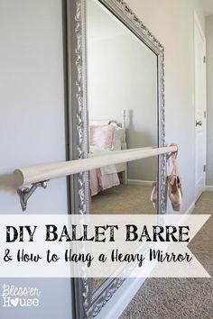 a large mirror sitting on top of a wall next to a door way with the words diy ballet bare and how to hang a heavy mirror