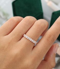 a woman's hand with a diamond ring on it