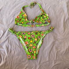 Nwt Gorgeous Vintage Moschino 1990s Neon Green Flower Printed 90s Two Piece String Bikini Sexy New Vintage Moschino Bright Neon Green 90s Swimsuit! Features Colorful Flowers Printed In Pink, Fuchsia, Yellow, And Purple. Ties At Each Side Of The Waist, And At Front Bust. Super Flattering String Bikini Great For The Pool Or Beach! In Great Unworn Condition. Made In Italy. Approximately Size Xsmall / Small (Very Stretchy, And Ties Can Be Adjusted To Fit Many Sizes Trendy Green Floral Print Swimwear, Green Retro Triangle Top Swimwear, Retro Floral Print Swimwear For Pool, Retro Fitted Floral Print Swimwear, 90s Bikinis Vintage, 90s Swimsuit, Purple Ties, Vintage Moschino, Yellow And Purple