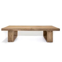 a wooden table sitting on top of a white wall