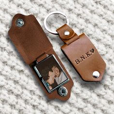 a brown leather keychain with a couple's photo attached to it