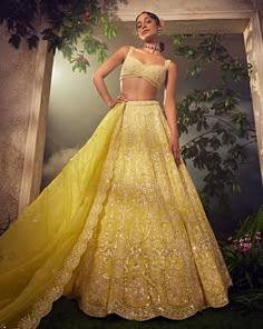 Featuring a prime yellow organza lehenga embroidered fully by hand with various ornamental sequences and Japanese bugle beads. It is paired with a scallop dupatta and a stylised blouse .From Aneesh Agarwaal's Ellora collection.DELIVERY TIMEPlease allow 8-12 weeks for your outfit to arrive.FABRIC DETAILSNetProfessional cleaning only. Lehenga Designs Light Color, Summer Lehenga Designs, Moti Work Lehenga, Pastel Yellow Lehenga, Yellow Indian Wedding Dress, Bridal Haldi Outfit Indian, Desi Wedding Outfits, Yellow Organza Lehenga, Yellow Bridal Lehenga