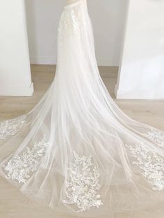 a white wedding dress on display in front of a mannequin's head