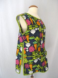 a mannequin wearing a colorful vest with fruit and vegetables on it