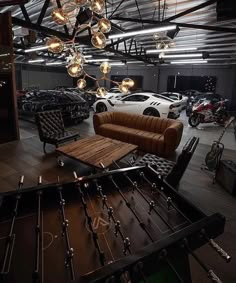 a living room filled with furniture and lots of lights hanging from it's ceiling