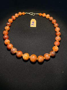 The beautiful orange color carnelian beads necklace from Himalaya Nepal This beads were used in prayer malas and used as jewelry and amulets in ancient times very smooth and shinny surface of this beads because of passage of time and usage of this beads in prayers mala and in necklace The age of this beads are more than 1000 years small size gold color brass beads are used as spacers in the necklace we provide fast and free shipping service to our customers by which can get the items by maximum Orange Single Strand Spiritual Necklace, Orange Carnelian Necklace In Spiritual Style, Spiritual Orange Agate Necklace, Traditional Orange Necklace With Natural Stones, Traditional Orange Carnelian Beaded Necklace, Round Carnelian Orange Beads, Hand-strung Orange Carnelian Beaded Necklaces, Handmade Carnelian Orange Beads, Hand-strung Orange Carnelian Necklaces