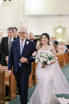 the bride and groom are walking down the aisle