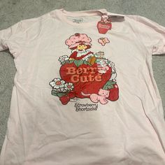 Brand New Pink Strawberry Shortcake Tshirt. Adult Large. Sweet Graphic Print Crew Neck Tops, Sweet Style Crew Neck Tops With Graphic Print, Sweet Short Sleeve Tops With Funny Print, Sweet Short Sleeve Tops With Graphic Print, Casual Crew Neck Shirt With Strawberry Print, Sweet Tops With Funny Print And Crew Neck, Cute Crew Neck Shirt With Strawberry Print, Fun Pink Tops With Strawberry Print, Casual Strawberry Print Crew Neck Shirt