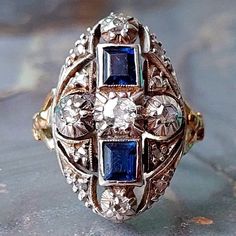 A women's fabulous antique ring featuring a cluster of natural gemstones set in solid 18ct white gold, the shank of the ring with its open shoulder design is all 18ct yellow gold, c.1890s-1900s. The ring features lovely quality sapphires of approx 0.25 carats each, the round old cut diamonds range from 15 points to 1 1/2 points each, a fine etched border surrounds the precious stones.  The ring is being offered in excellent antique condition and has been tested as such.  Uk size M Us size 6 1/4 Antique Sapphire Ring With 17 Jewels, Exquisite Sapphire Diamond Ring With 17 Jewels, Heirloom Sapphire Diamond Ring With Multi-stone, Exquisite Multi-stone Sapphire Ring In White Gold, Exquisite Multi-stone White Gold Sapphire Ring, Heirloom White Gold Sapphire Ring With Multi-stone, Heirloom Style Multi-stone Sapphire Ring In White Gold, Antique Blue Diamond Ring Hallmarked, Victorian Sapphire Ring With Diamond Oval Shape