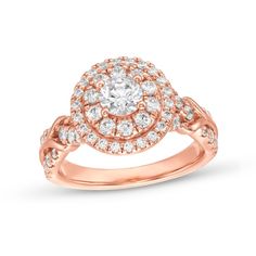 a rose gold ring with diamonds on the band and an oval center stone in the middle