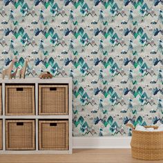 a room with a basket and wallpaper on the floor, next to a dresser