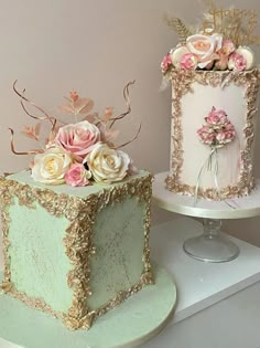 there are two cakes on the table and one is decorated with pink, white and gold flowers