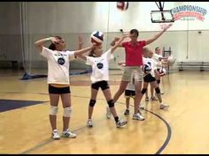 the girls are playing volleyball on the court with their hands in the air and one girl has her arms up