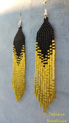 yellow and black beaded earrings hanging from hooks