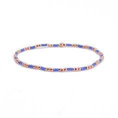 Pretty in Periwinkle Beaded Bracelets Band: Flat woven; 1/2"w; 14K yellow/rose gold-filled or sterling silver clasp & 1" extender chain; glass seed beads. Strands: Stretch style; 14K yellow/rose gold-filled or sterling silver round 2mm, 3mm & 4mm beads; glass seed beads. Wrap: Stretch style that will wrap around the wrist 3 times (can also be worn as a necklace); glass seed beads. (When adding to cart, select your single bracelet size, and it will be multiplied in length by three when made). Sho Blue Bracelets With Gold Beads In Dainty Style, Blue Dainty Bracelets With Gold Beads, Dainty Blue Beaded Bracelets With Gold Beads, Rose Gold Bracelets With Colorful Round Beads, Rose Gold Bracelet With Colorful Round Beads, Rose Gold Bracelet With Tiny Round Beads, Woven Beaded Bracelets, Rose Gold Beaded Bracelet, Bracelets Stack