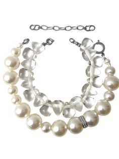 A set of 2 necklaces. One medium-sized simulation pearls, one choker necklace of resin, tooth-shaped clear beads. You can wear the set or wear one or the other. The clear beads necklace contrasts the pearls' formality but also brings out the shine of the beads. The combination of styles is a unique statement for day or night. The necklace includes an extension to elongate both necklaces as a set or only one. This item sells as a set.
The clear beads choker measures 15 IN/5 OZ.
The pear beads necklace measures 19 IN/6 OZ.
Extension up to 5 IN.
A set 19 IN/11 OZ White Beaded Necklace With Pearl Charm For Party, White Beaded Chain Choker For Party, White Double Strand Pearl Necklace For Party, White Pearl Charm Choker For Party, Adjustable Clear Necklace For Party, White Double Strand Beaded Necklace For Party, White Double Strand Necklace For Party, Elegant Adjustable Clear Beaded Necklaces, Elegant Clear Beaded Chain Necklace