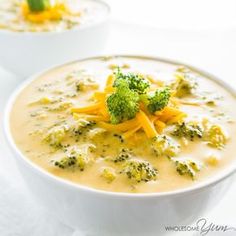 two white bowls filled with broccoli cheese soup