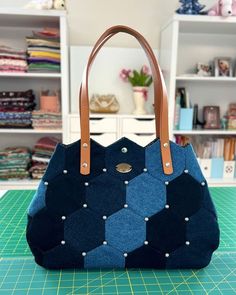 a handbag sitting on top of a cutting board