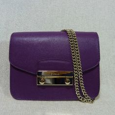 Baby Julia Shoulder Bag By Furla. This Shoulder Bag Is Made Of Adorable Eggplant Purple Saffiano Leather. Gold Tone Hardware Dimensions: 6.5" Widest X 4.5" Tall X 2 2/3" Deep. Comes With 50" Long Chain Shoulder Strap. Can Be Carried As Cross Body Bag, Doubled The Chain Strap And Carry Is As Shoulder Bag Or Carry It As A Clutch Flap And Lock Closure. These Are The Newer Version Of Baby Julias So They No Longer Come With Key Bells And Keys. Fabric Interior Lining With 3 Card Slots. It's In Solid P Luxury Purple Shoulder Bag For Formal Occasions, Luxury Purple Evening Bags, Luxury Purple Formal Shoulder Bag, Luxury Purple Formal Bag, Luxury Purple Formal Bags, Luxury Purple Bag With Branded Hardware, Classic Purple Evening Bag, Elegant Purple Shoulder Bag, Luxury Purple Shoulder Bag With Detachable Strap