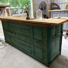 an old wooden bar is being worked on in a garage with tools and other items