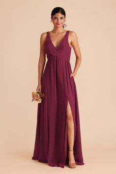 a bridesmaid in a deep purple dress with a slited leg and low back