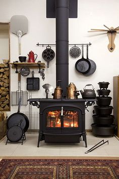 a stove with many pots and pans on the wall