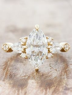 an engagement ring with three pear shaped diamonds