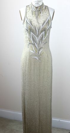 "There is actually a jacket that comes along with this..that is also quite stunning. Fabulous dress for a wedding. long high necked gown with beautifully beading silver, gold, ivory and silver..just outstanding. Excellent condition Dress: Measuring: 59\" long Bust: 36\"+ 38 Waist: 30\" Hip: 36\"+ 38\" (some stretch in the bust and hip) Jacket Measuring: 30\" length Width: 40\" Sleeves: 24\" There are shoulder pads in this Beautiful beaded jacket Pet Free/smoke free Enjoy!" Elegant Fitted Sparkling Gown, Elegant Sparkling Evening Dress For Wedding, Elegant Sparkling Wedding Evening Dress, Fitted Sequin Mother Of The Bride Dress, Elegant Sparkling Gold Gown, Elegant Gold Sparkling Gown, Fitted Sequin Evening Dress For Mother Of The Bride, Mother Of The Bride Fitted Sequin Evening Dress, Elegant Sequined Mother Of The Bride Dress