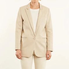 Step up your fashion game with our Off-White Lambskin Leather Blazer for Women. Made with high-quality lambskin leather, this blazer is the perfect addition to any stylish wardrobe. This blazer will make you feel confident, powerful, and stylish. You will turn heads wherever you go and feel comfortable while doing it. Whether you're attending a formal event or just running errands, this blazer will make you feel put together and ready to take on the world. Feel confident and powerful with this c Beige Leather Blazer For Office, Spring Cream Business Blazer, Cream Business Blazer For Spring, Cream Business Blazer For Fall, Cream Blazer For Business In Fall, Elegant Cream Leather Jacket For Spring, Fall Business Cream Blazer, Beige Leather Blazer For Spring, Classic Beige Leather Jacket For Work