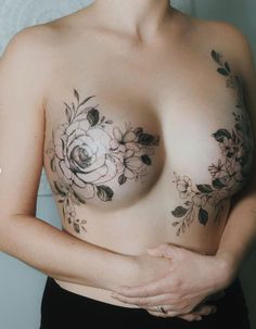 a woman's breast with flowers and leaves painted on her chest is shown in this image