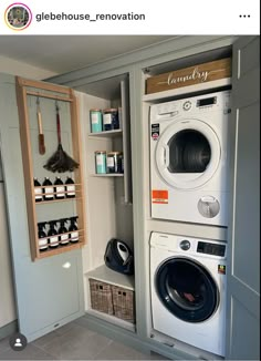 a washer and dryer in a room with shelves on the wall next to each other